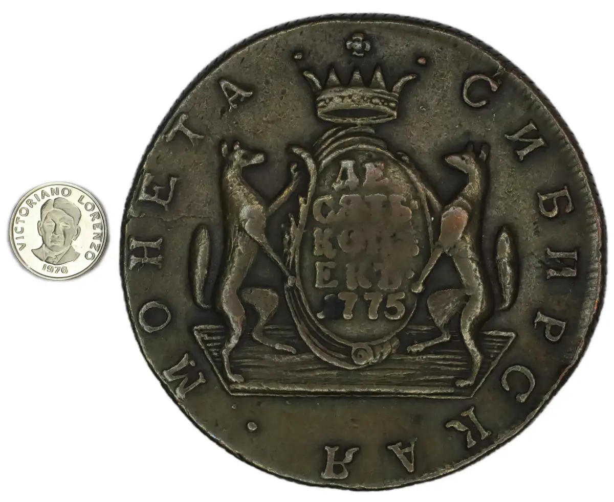 A large, tarnished historical coin with a crown, shield, and two standing dogs, dated 1775, is shown next to a modern…