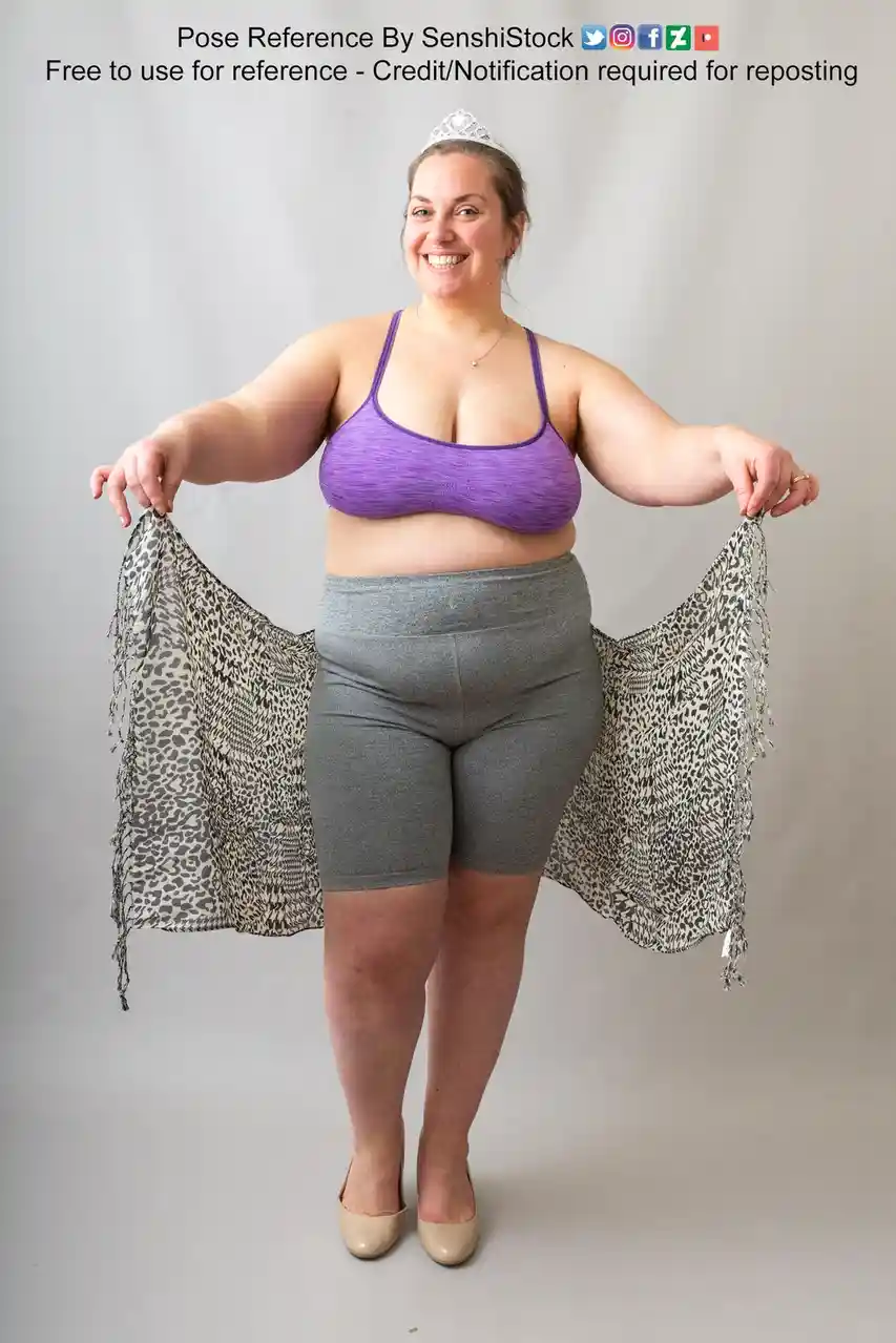 A woman wearing a purple sports bra, grey shorts, and a tiara stands smiling while holding a leopard-print scarf open like…