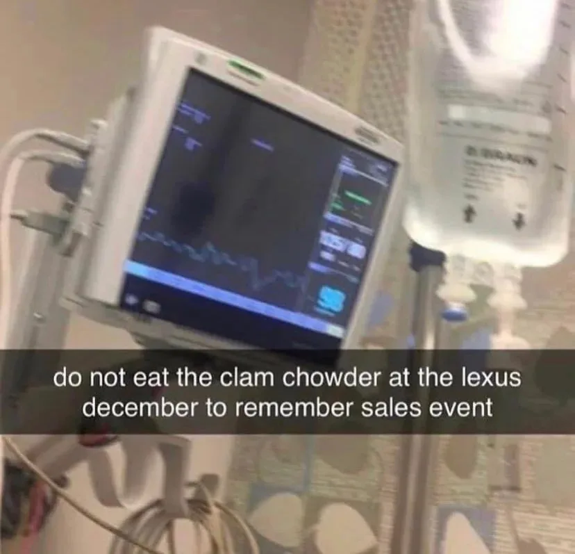 A blurry photo of a hospital room showing a medical monitor displaying a flatline EKG and an IV bag labeled 'D5W' hanging…