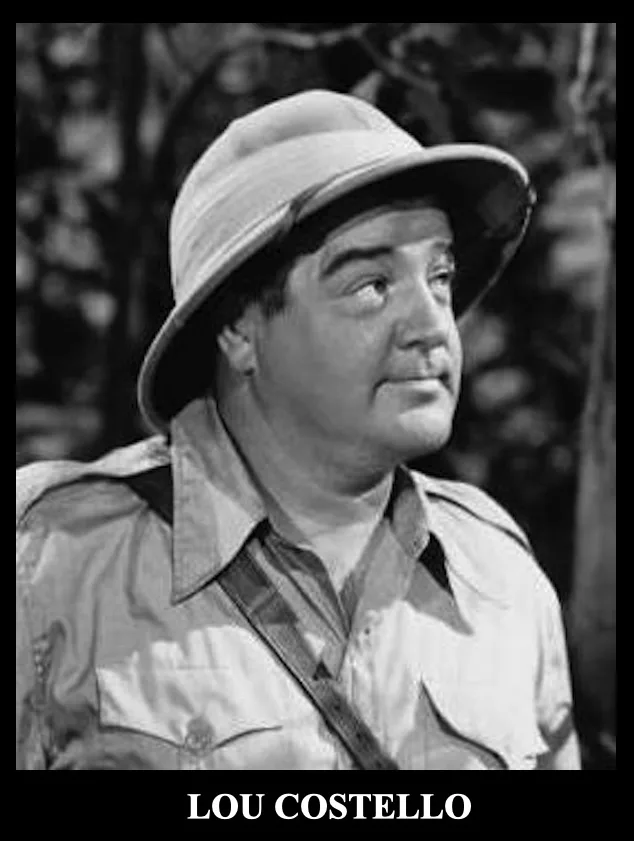 A black-and-white photo of actor Lou Costello wearing a safari-style pith helmet and a light-colored shirt with a strap…