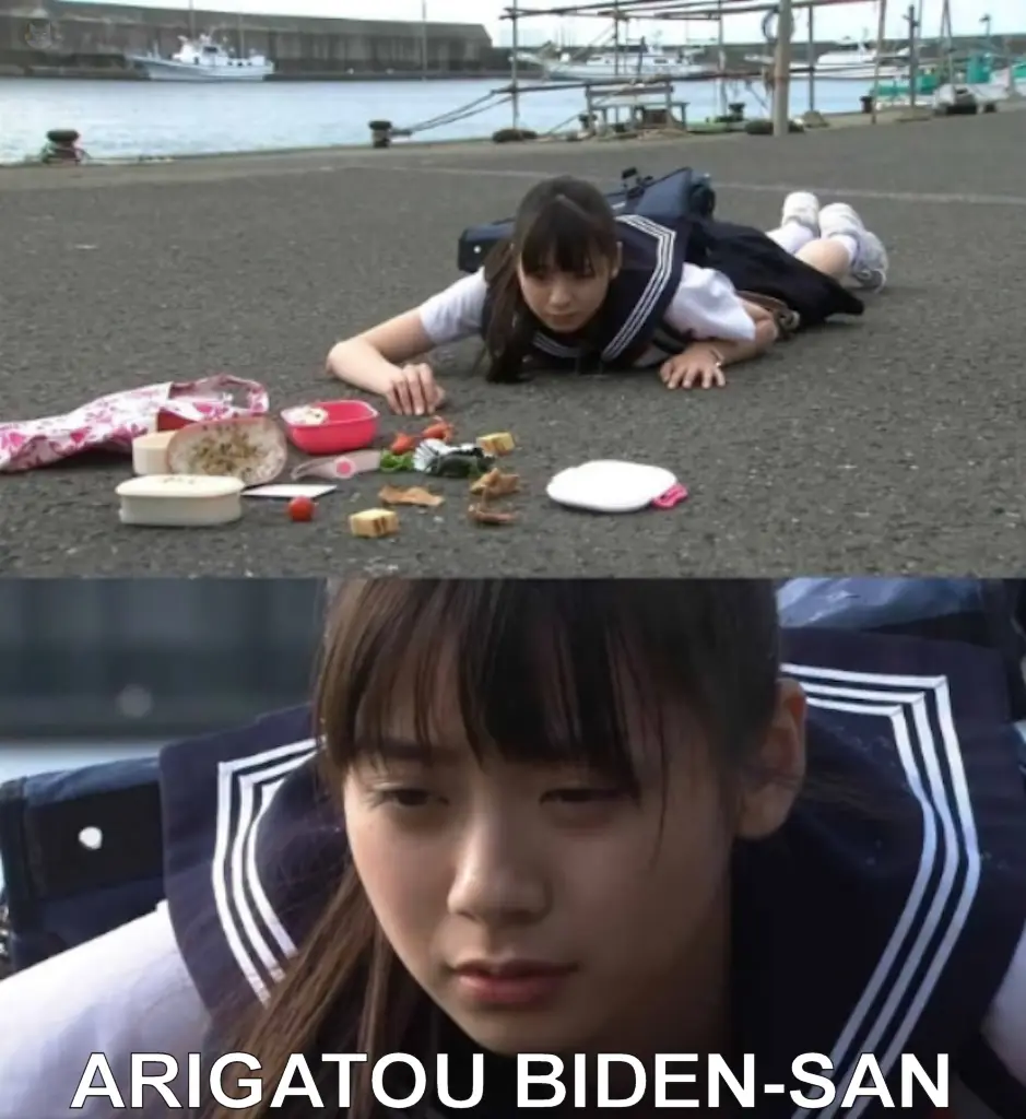 A young Japanese girl in a school uniform lies on asphalt next to scattered bento box food, looking downcast. The bottom…