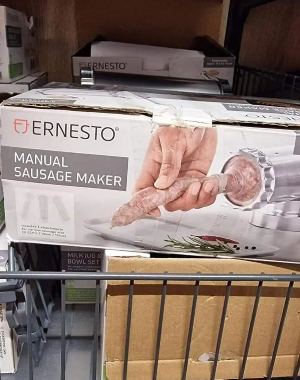 A product box for an 'Ernesto Manual Sausage Maker' sits on a store shelf, showing a hand holding a sausage being extruded…