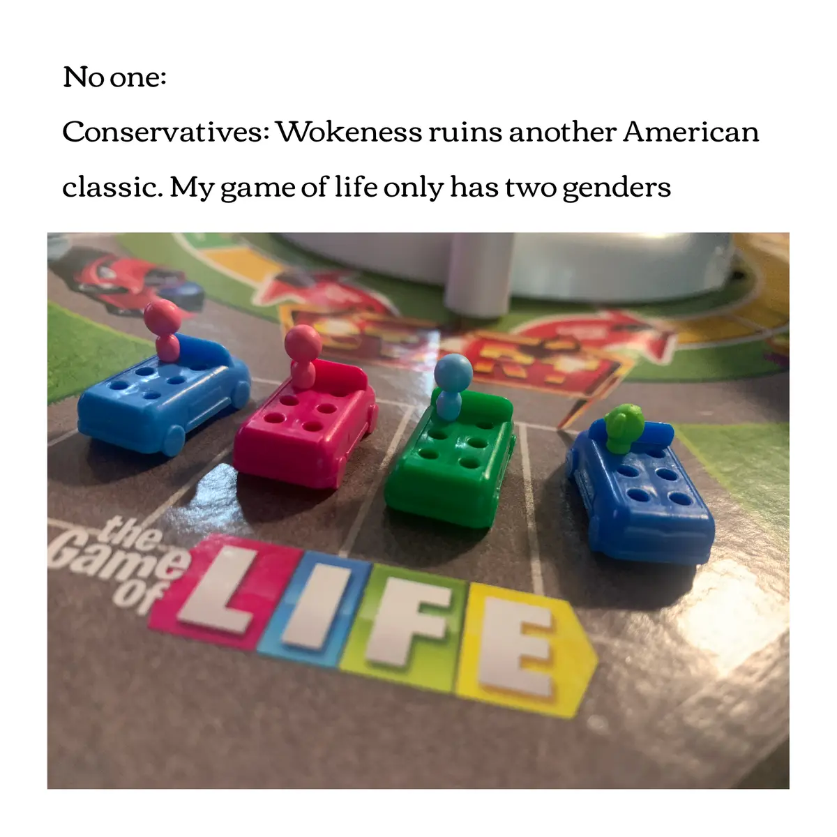 The image shows four plastic toy cars from 'The Game of Life' board game, each with a small, round-headed figurine on top…