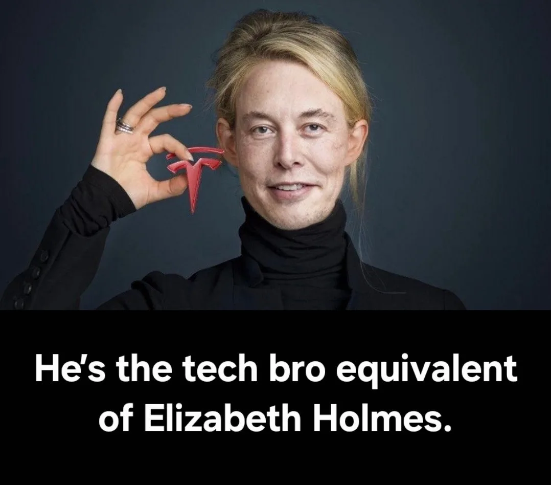 A person with blonde hair and a black turtleneck holds a red Tesla logo near their ear against a dark background. The image…