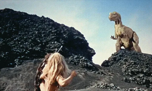 A six-panel image sequence from a movie shows a woman with long blonde hair facing a large, bipedal dinosaur on a rocky…