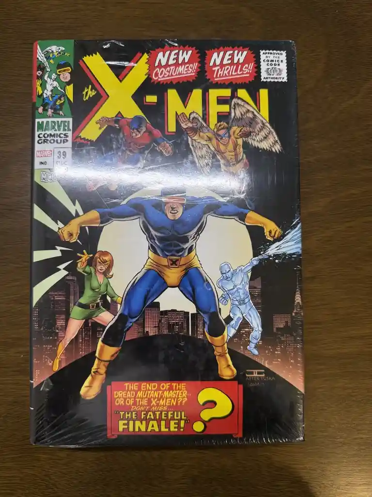 A vintage X-Men comic book cover, issue #39, featuring Cyclops in a heroic pose with other X-Men characters around him. The…
