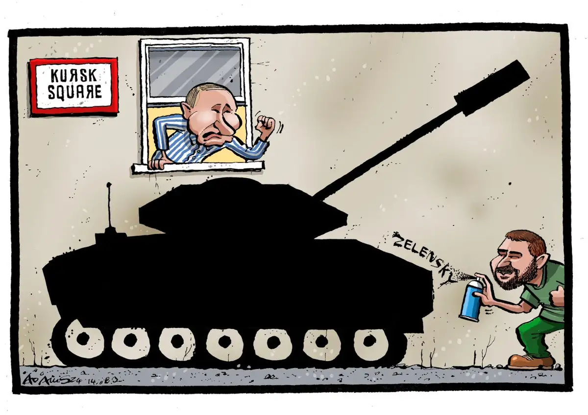 A cartoon depicts a man with a beard spraying the word 'ZELENSKY' onto the side of a black tank with a spray can. Another…