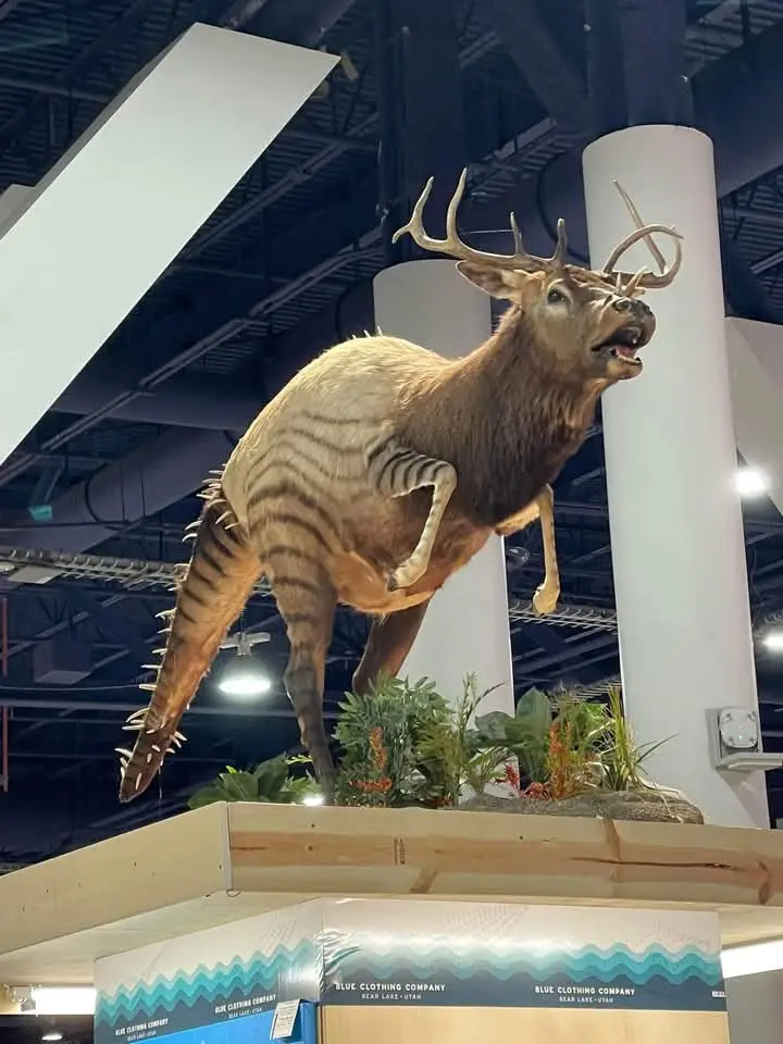 A taxidermied deer mount is displayed indoors, but its torso and hindquarters have been digitally altered to feature…