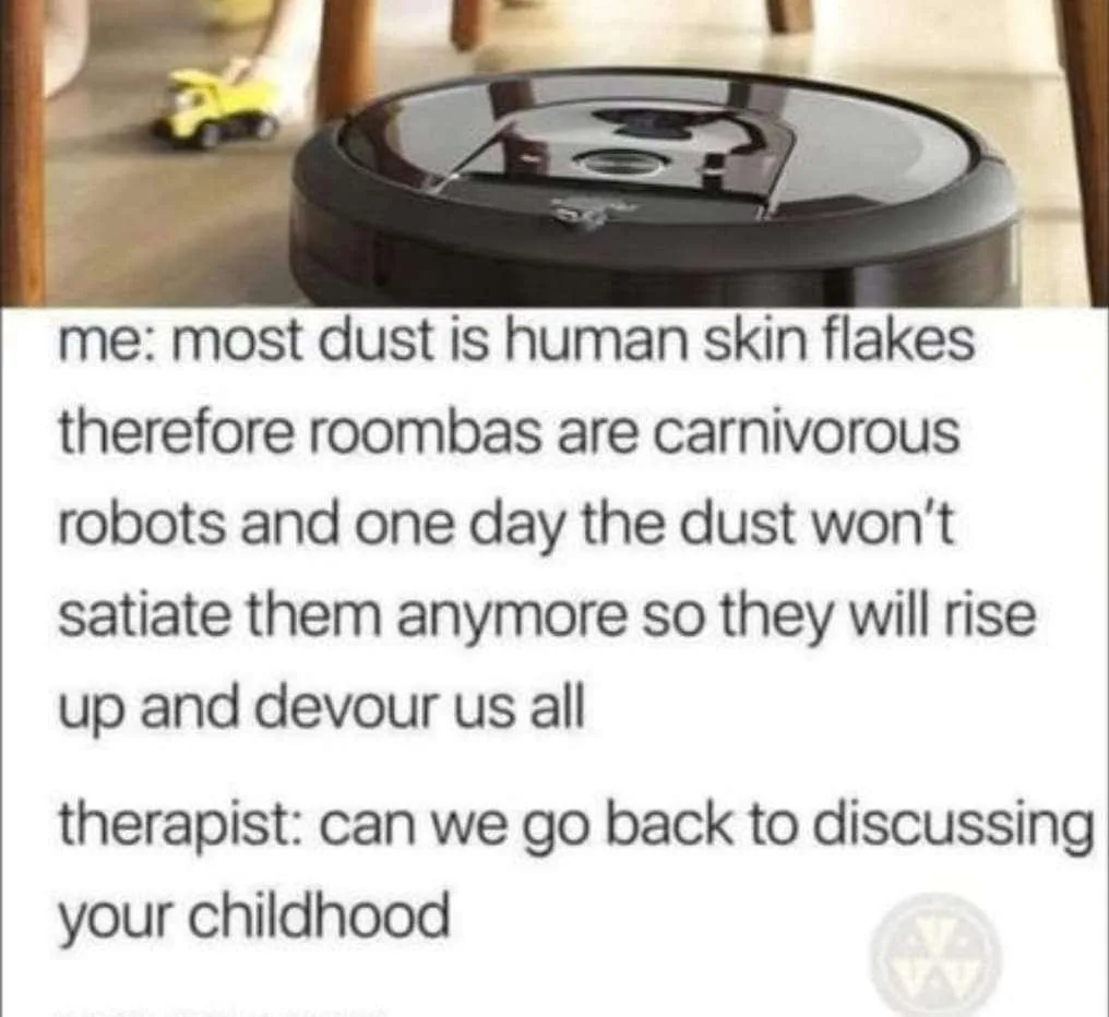 A black Roomba vacuum cleaner sits on a wooden floor with a yellow toy truck in the background. Overlaid text shows a…