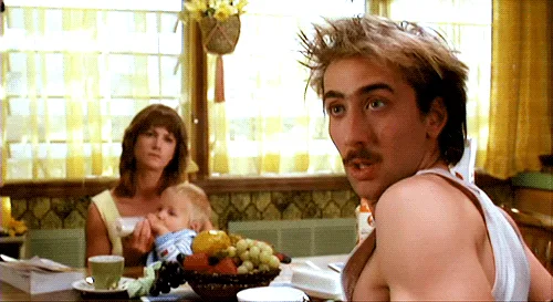 A composite image of six frames from the movie 'The Switch' (2003) showing actor Nicolas Cage in a white tank top, reacting…