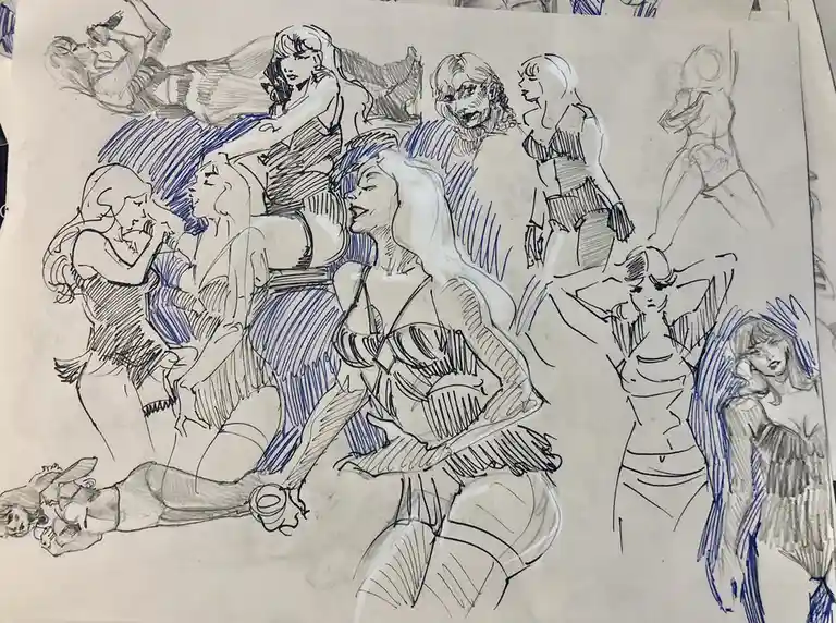 A sketchbook page filled with numerous pencil and blue ink drawings of various female figures in different poses and…