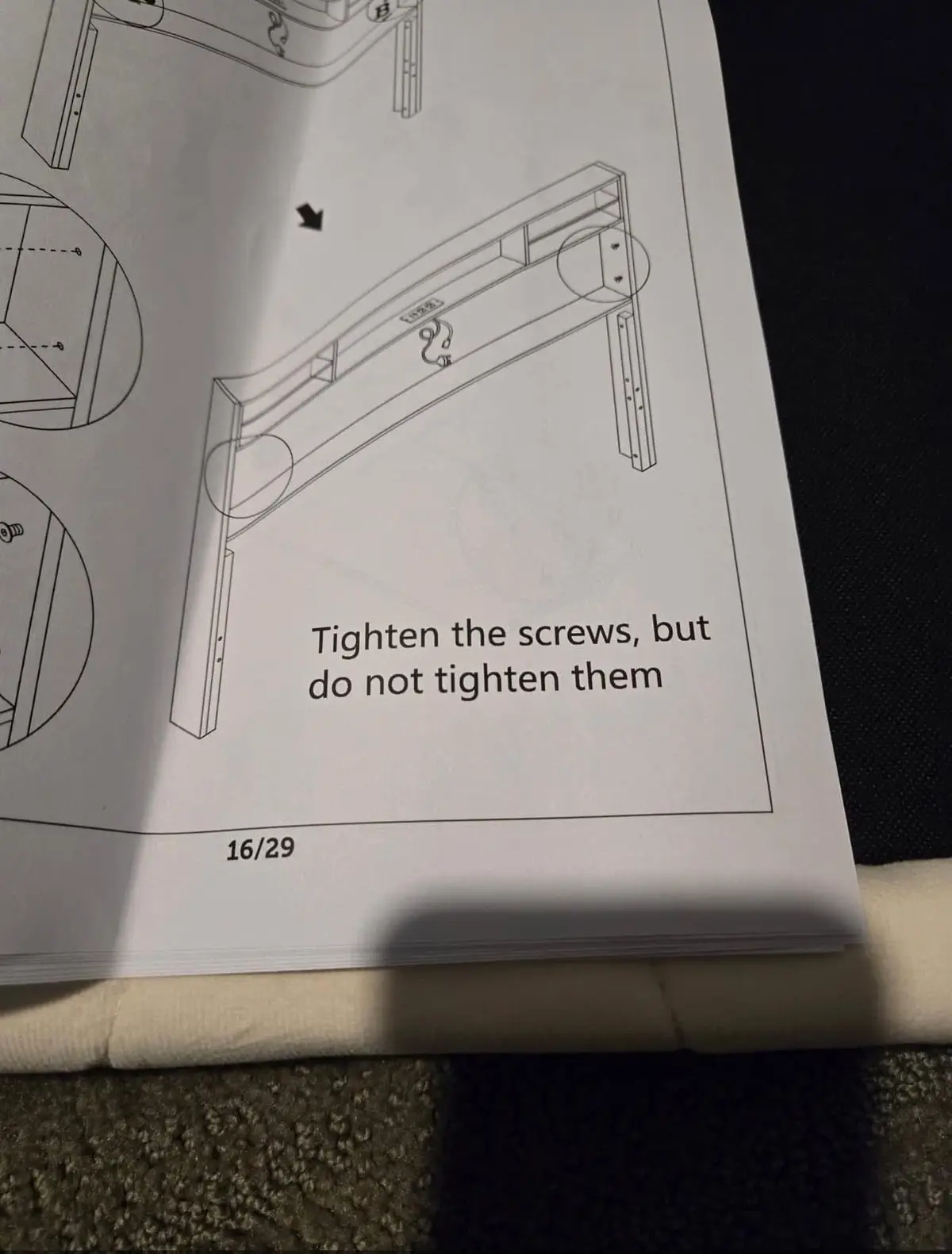 A close-up of a furniture assembly manual page showing a line drawing of a wooden frame with arrows and circles highlighting…