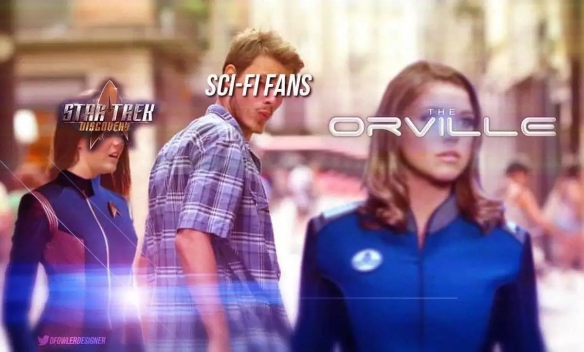 A man in a plaid shirt stands between two women in sci-fi uniforms, one labeled 'STAR TREK DISCOVERY' and the other 'THE…