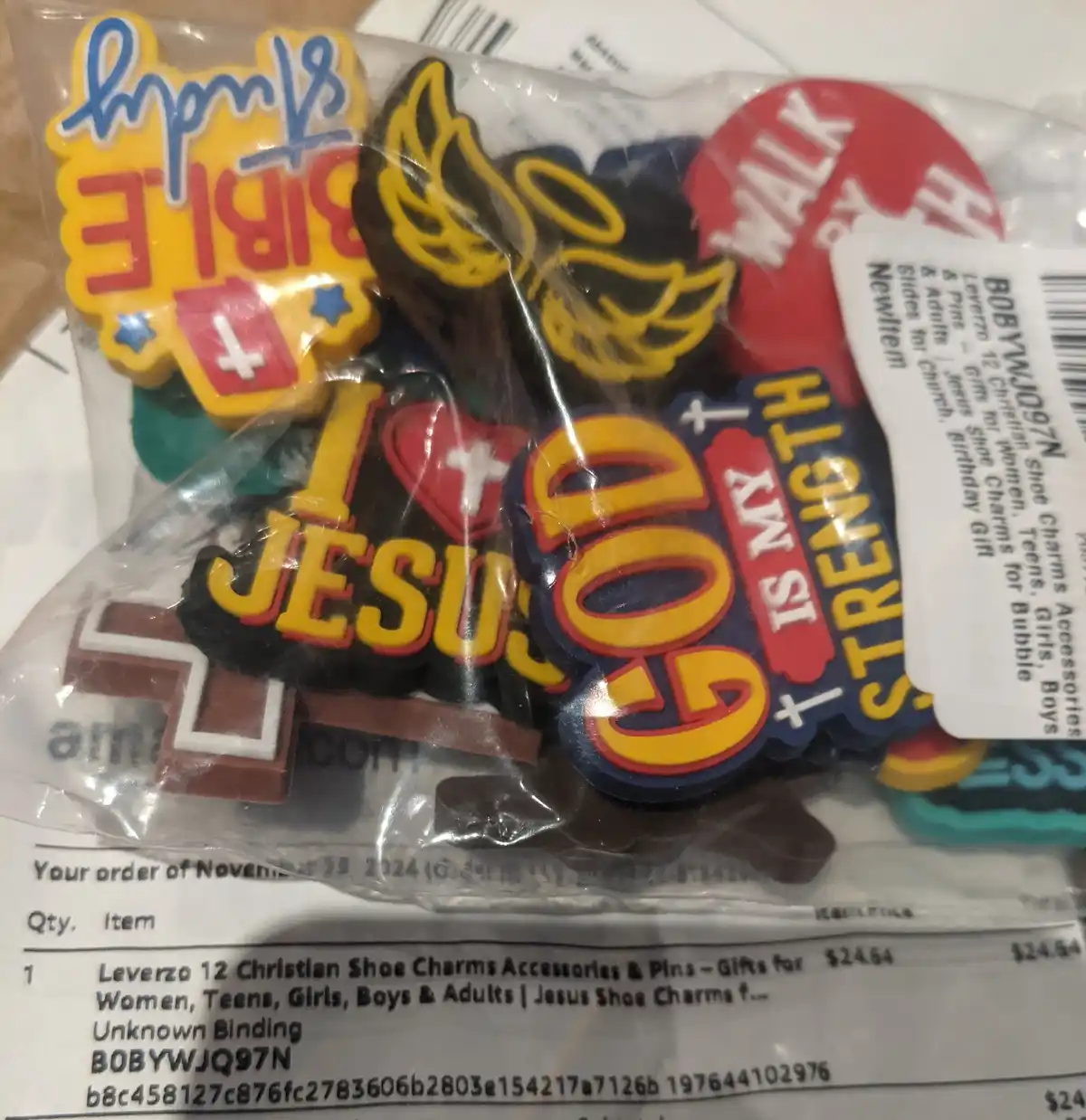 A close-up photo shows a clear plastic package containing 12 Christian-themed shoe charms, including designs like 'I love…