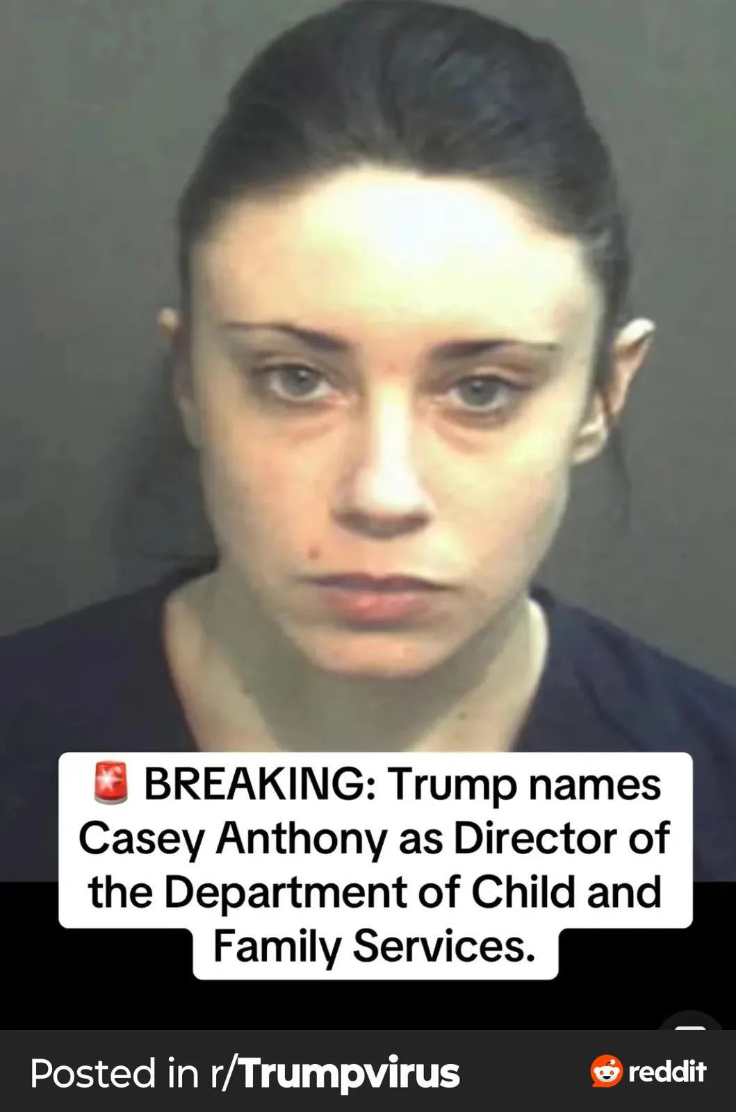 A mugshot of a woman with dark hair pulled back, wearing a dark shirt, stares blankly at the camera. Overlaid text reads…