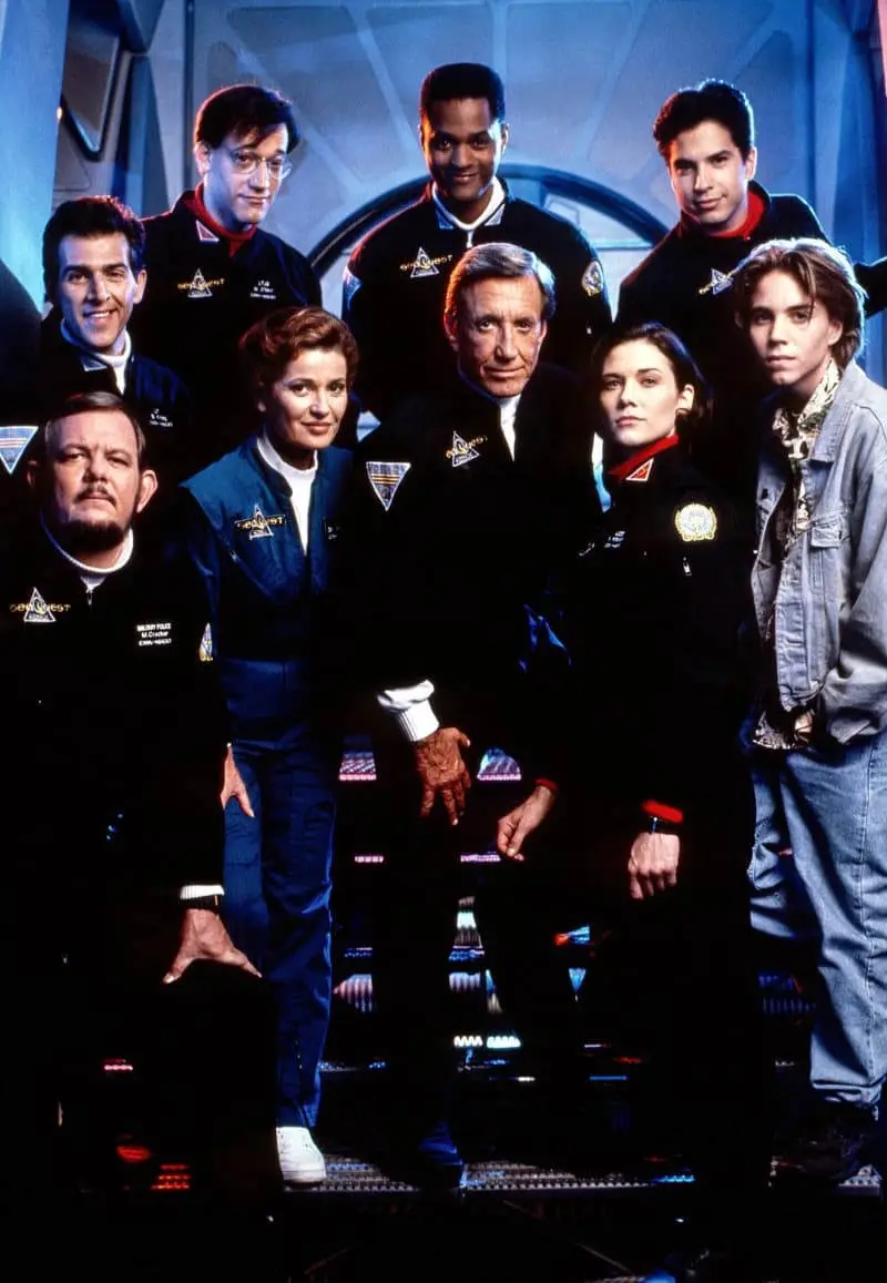 A promotional group photo of the cast of the TV show 'Star Trek: Voyager' in their uniforms, with the actor portraying the…