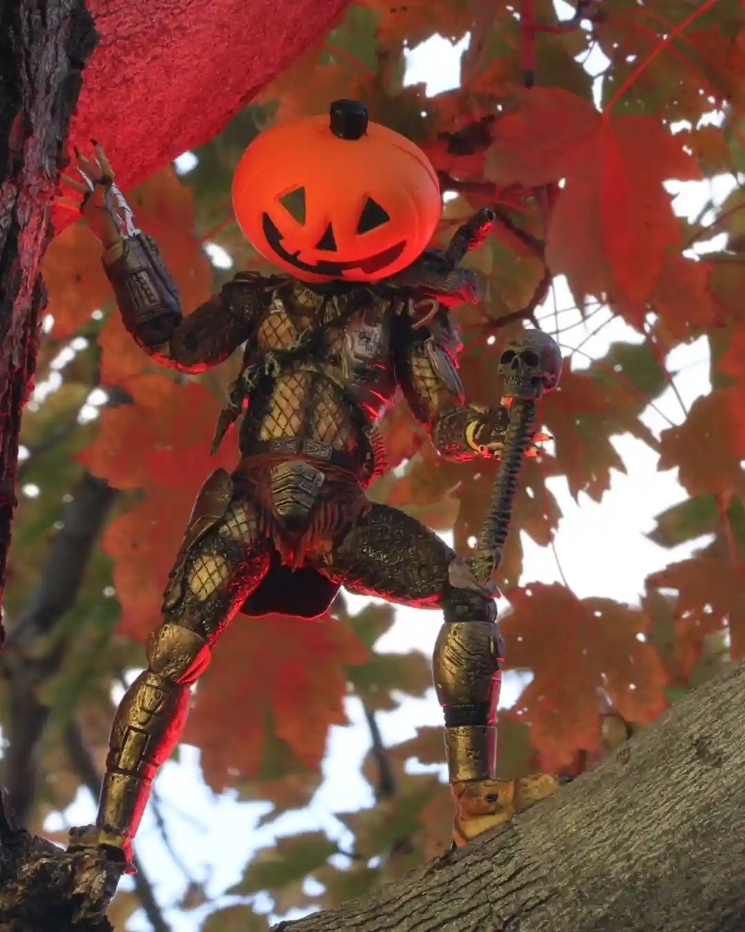 A detailed action figure of a warrior with a glowing orange jack-o'-lantern head, wearing ornate armor and holding a…