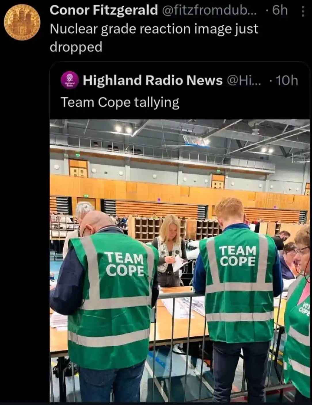 The image shows several people wearing green high-visibility vests with 'TEAM COPE' printed on the back, standing in what…