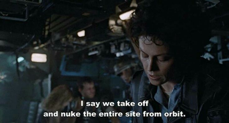 A still from the movie 'Alien' shows a woman with dark curly hair looking down in a dimly lit spaceship interior. The…