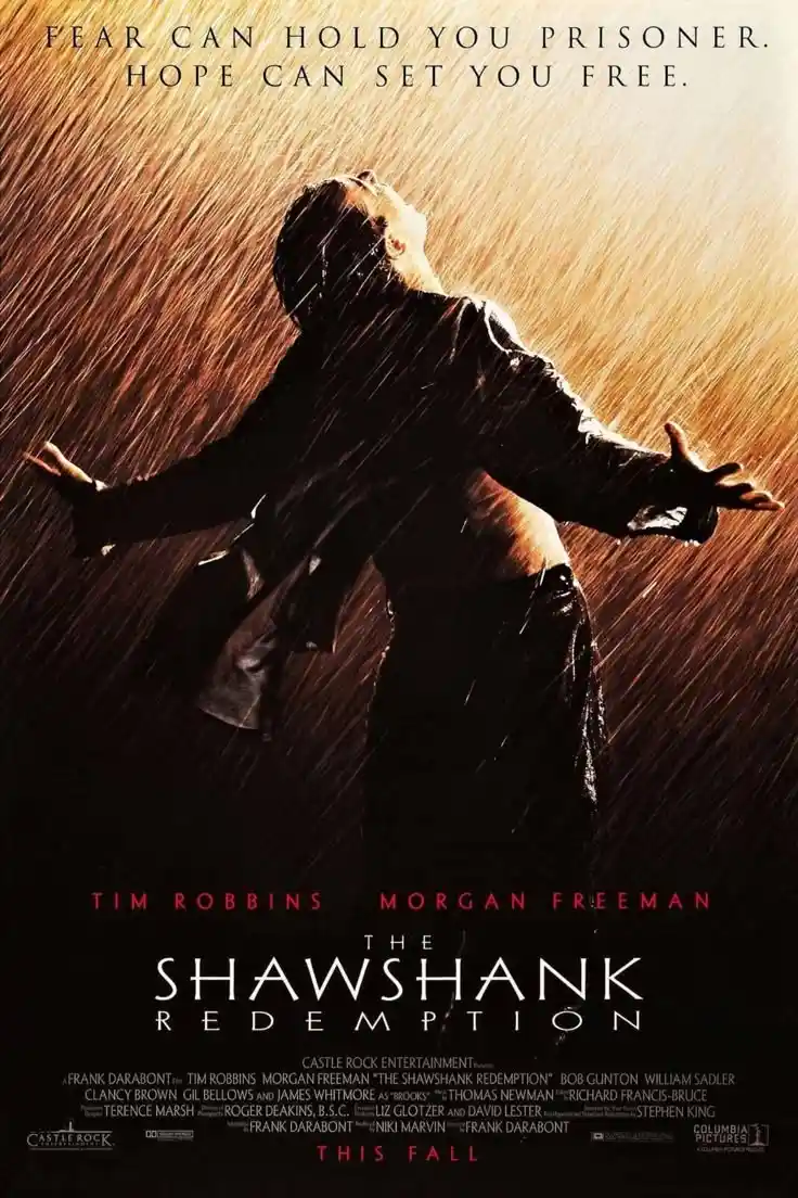 The image is a movie poster for 'The Shawshank Redemption' featuring a man in a rain-soaked scene with arms outstretched…