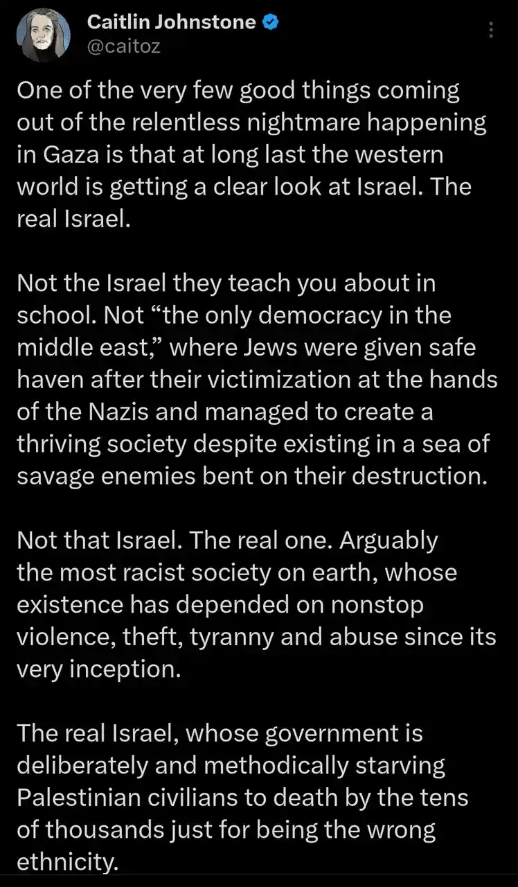A screenshot of a tweet by Caitlin Johnstone (@caitoz) with a black background and white text. The text is a lengthy…