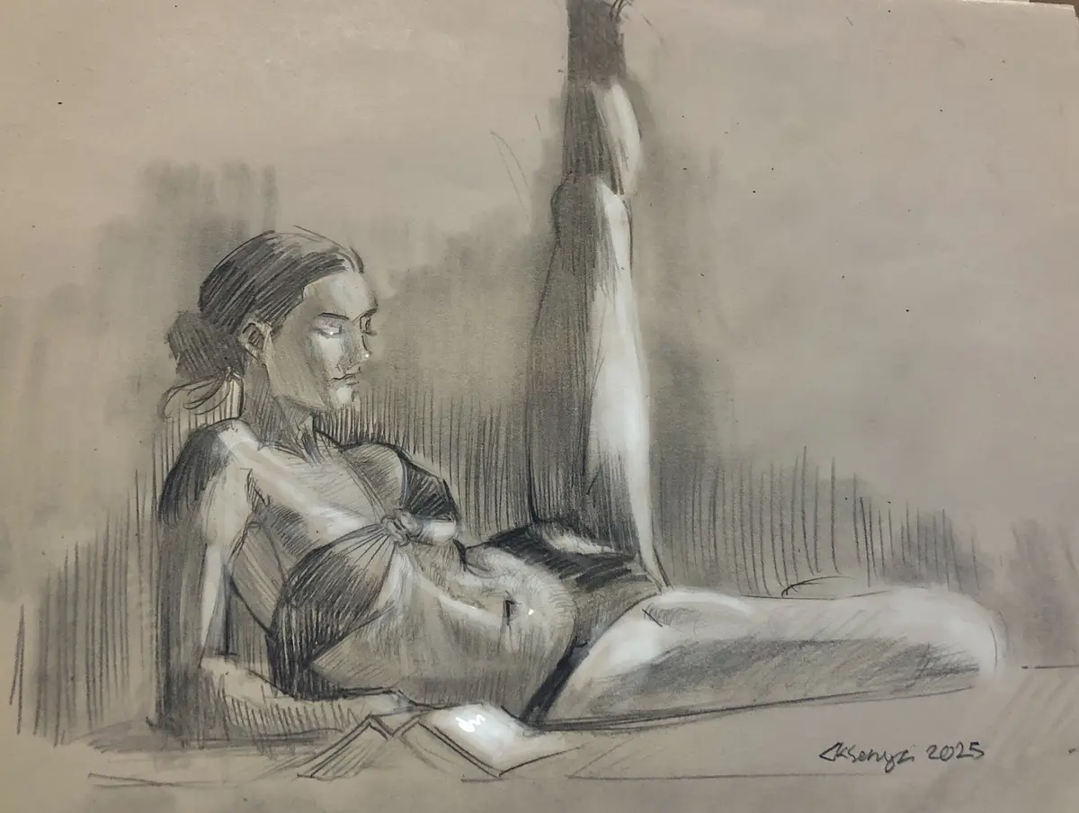 A charcoal sketch of a woman reclining with one leg raised, looking pensive while holding a book. The image has the…