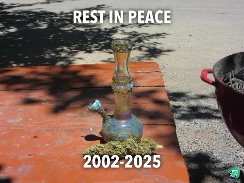 A glass bong sits on a weathered red picnic table outdoors, surrounded by dried cannabis buds. The text 'REST IN PEACE' is…