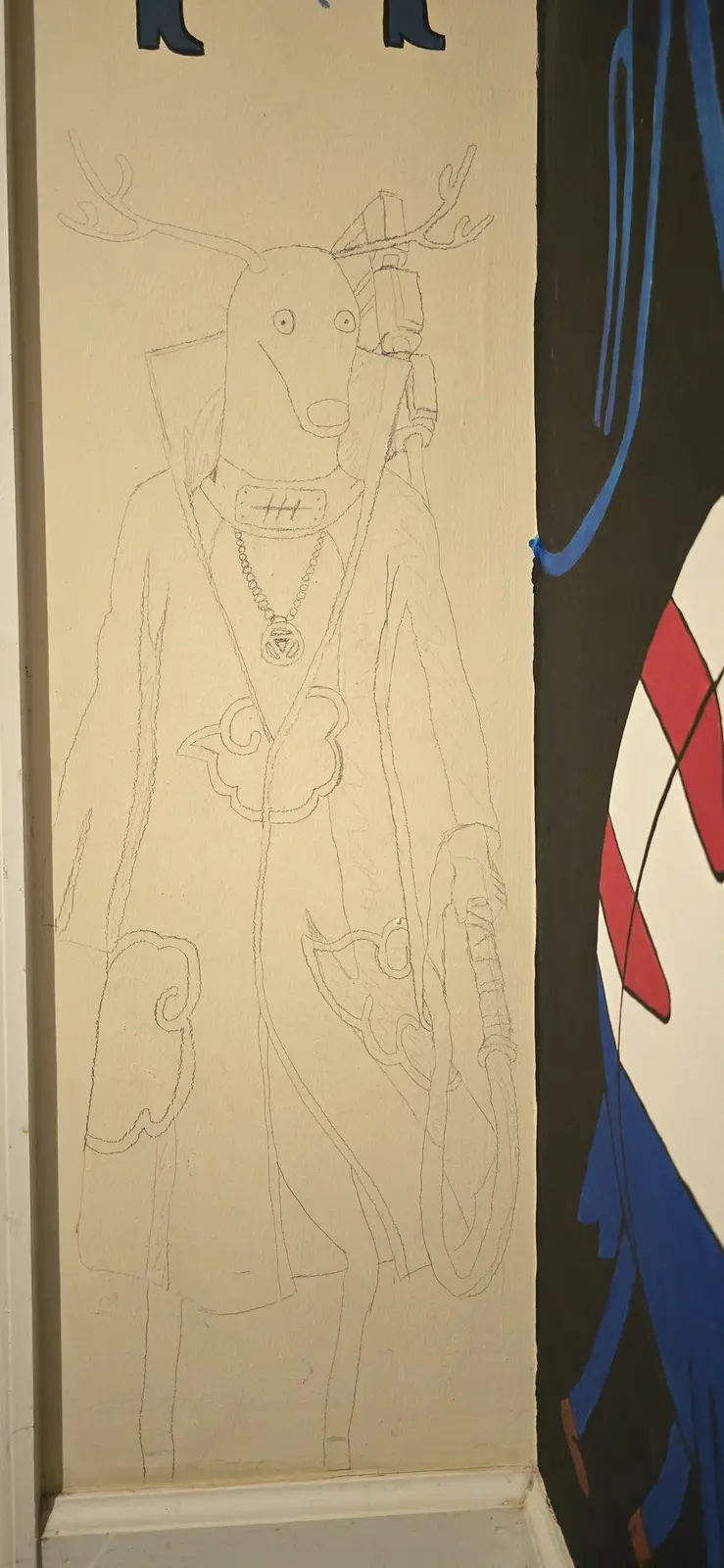 A pencil sketch on a wall depicts a deer-like creature wearing a coat, holding a gun, and sporting a necklace and antlers…