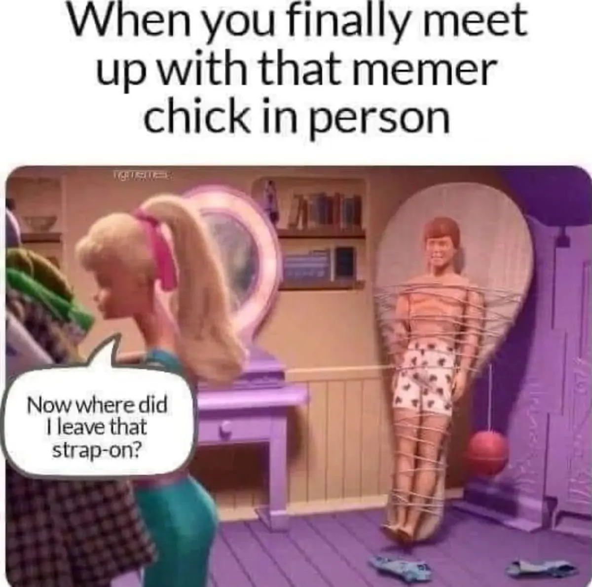 A Barbie doll with a ponytail looks at a Ken doll who is strapped to a heart-shaped chair with ropes, with a speech bubble…