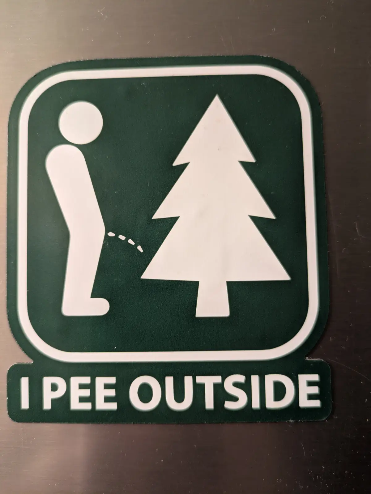 A green sticker with a white border shows a stick figure peeing on a pine tree, with the text 'I PEE OUTSIDE' below. The…