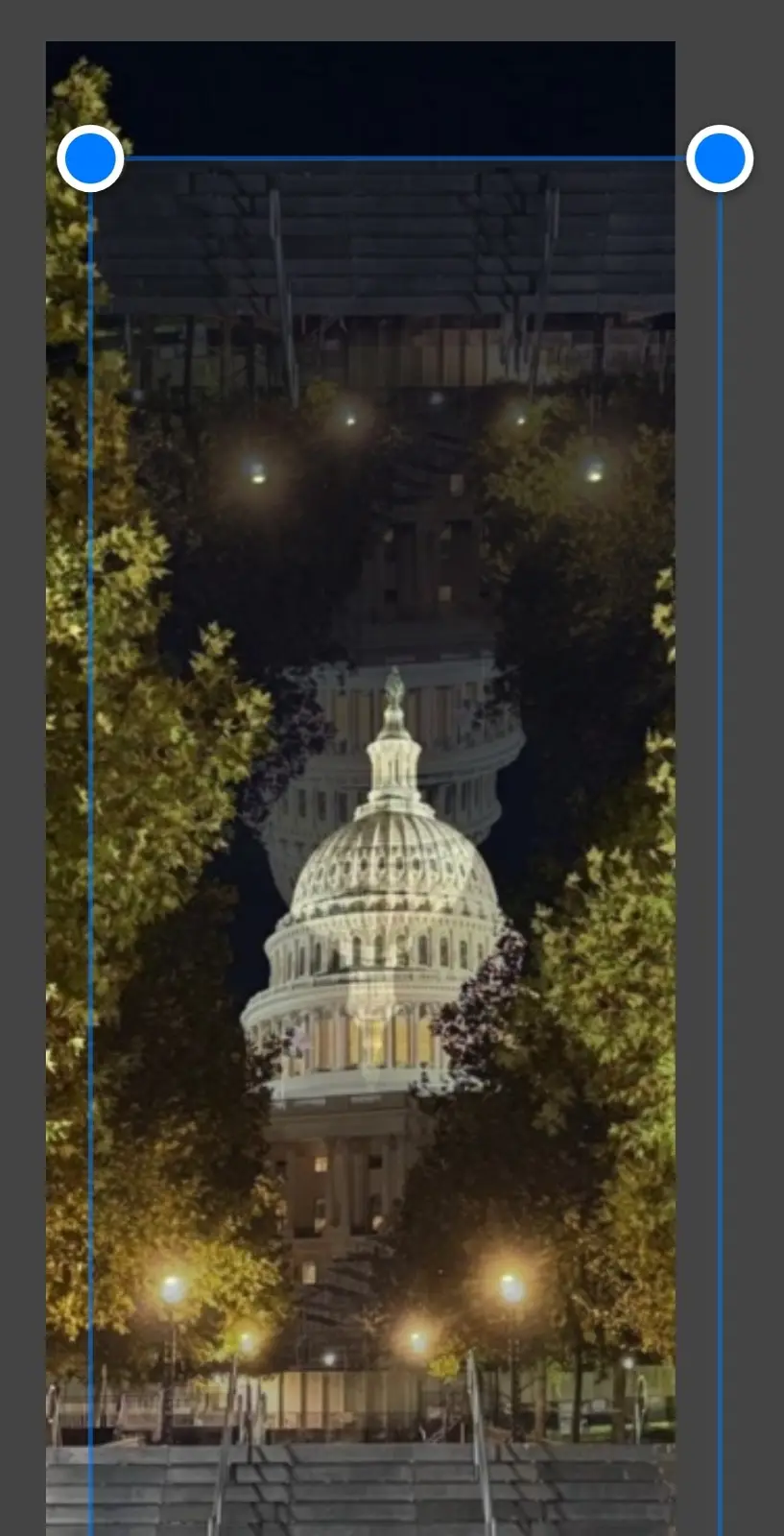 A nighttime photo of the U.S. Capitol building, framed by trees and illuminated streetlights, with a blue crop selection box…