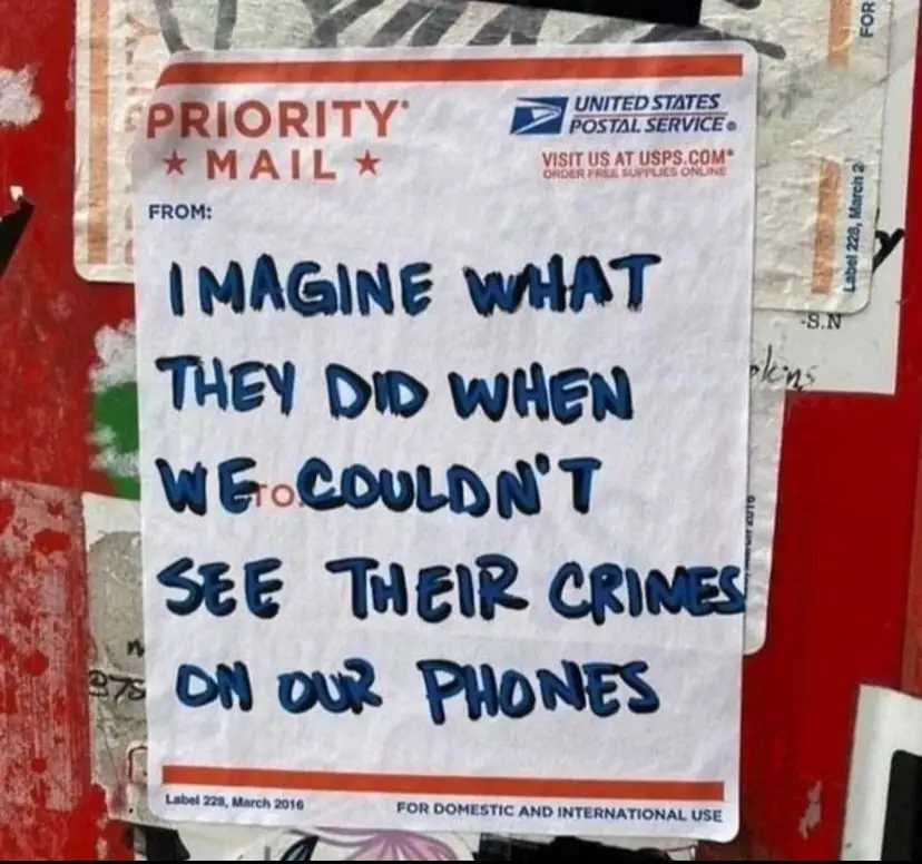 A handwritten message in blue marker is overlaid on a United States Postal Service Priority Mail label, which is stuck to a…