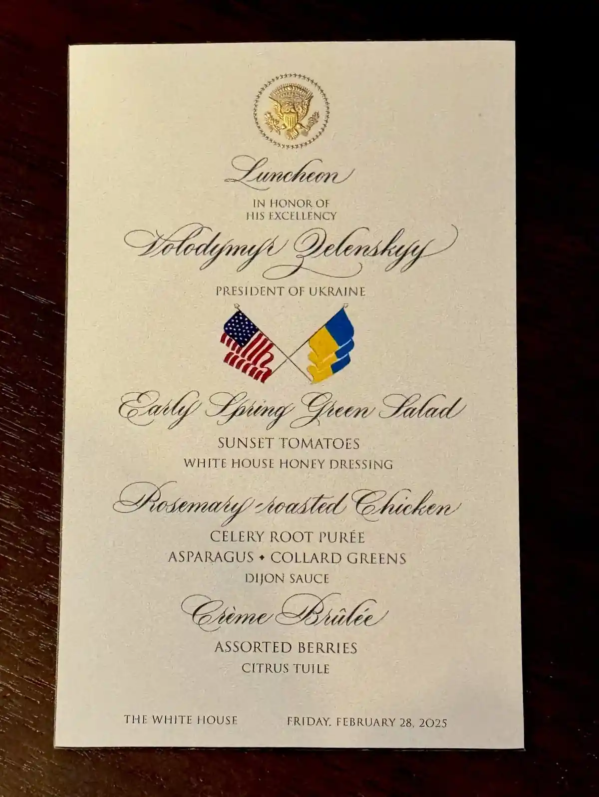 A formal White House luncheon menu for President Volodymyr Zelenskyy, featuring dishes like 'Rosemary roasted Chicken' and…