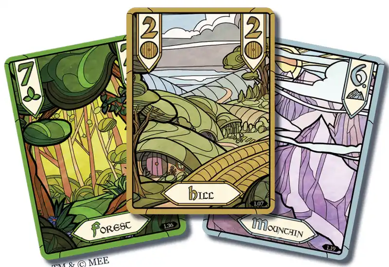 Three stylized fantasy terrain cards from a game are shown, with the central card labeled 'hicc' and displaying a green…
