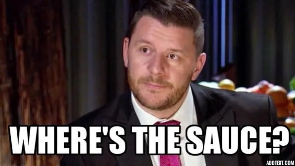A man in a black suit and pink tie stares with a skeptical, slightly confused expression. Large white text overlaid at the…