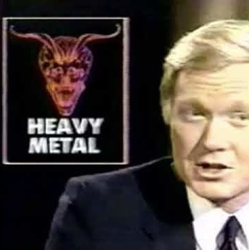 A man in a suit and tie is shown mid-speech, with a graphic overlay of a demonic face with horns and the words 'HEAVY METAL'…