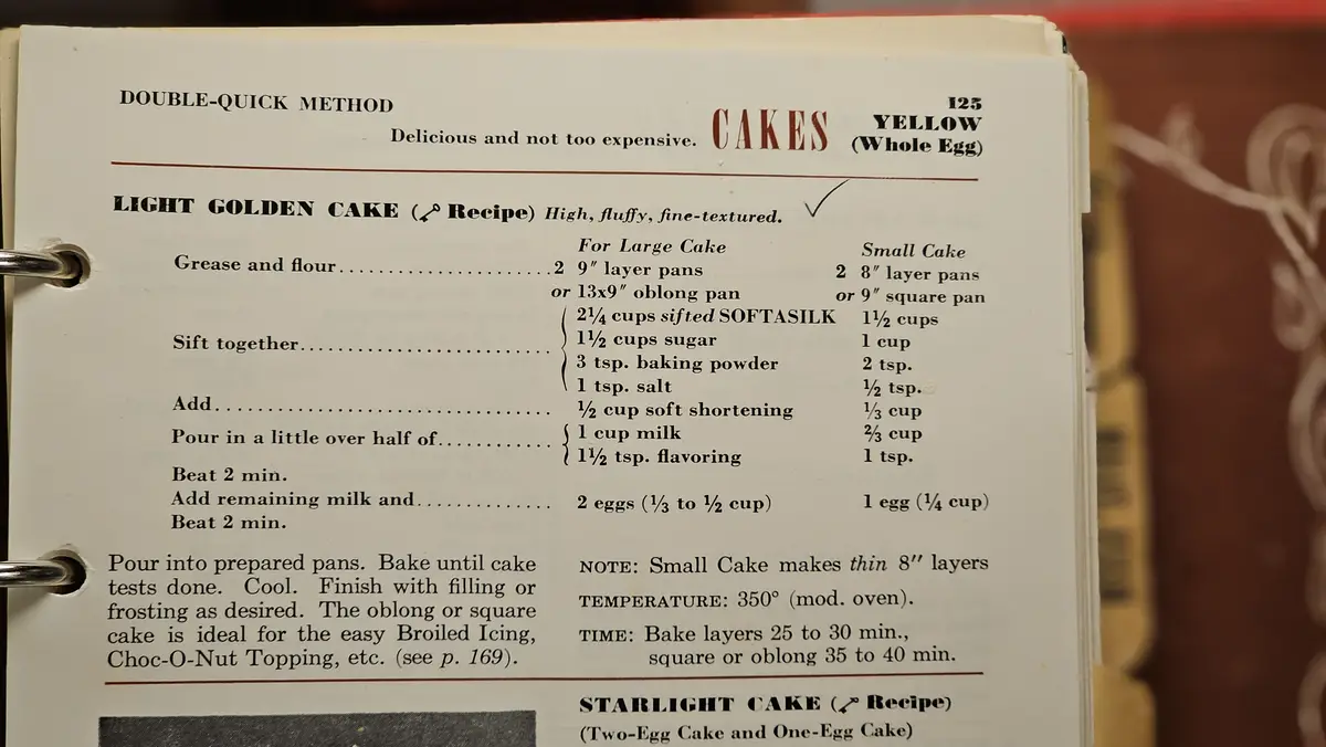 A close-up of a vintage cookbook page showing a 'Light Golden Cake' recipe under the 'CAKES' section, with a checkmark next…