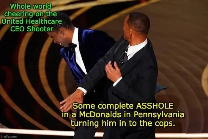 Two men in formal suits are shown on a stage with a golden spiral background, one is leaning forward with his hand out as if…