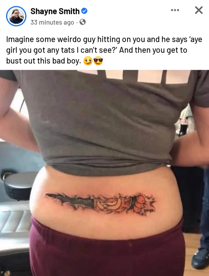 A person is shown from behind, wearing a grey crop top and maroon pants, revealing a tattoo on their lower back. The tattoo…