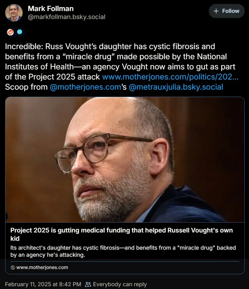 A screenshot of a social media post showing a photo of Russell Vought, a man with glasses and a beard, looking serious. The…