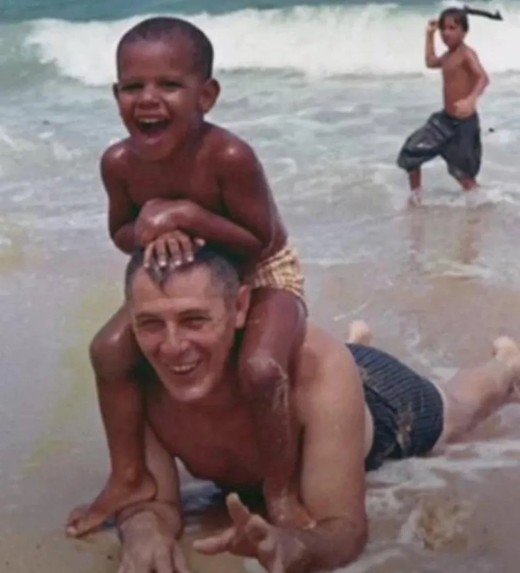A young Barack Obama enjoying a beach day with his grandfather in 1963.