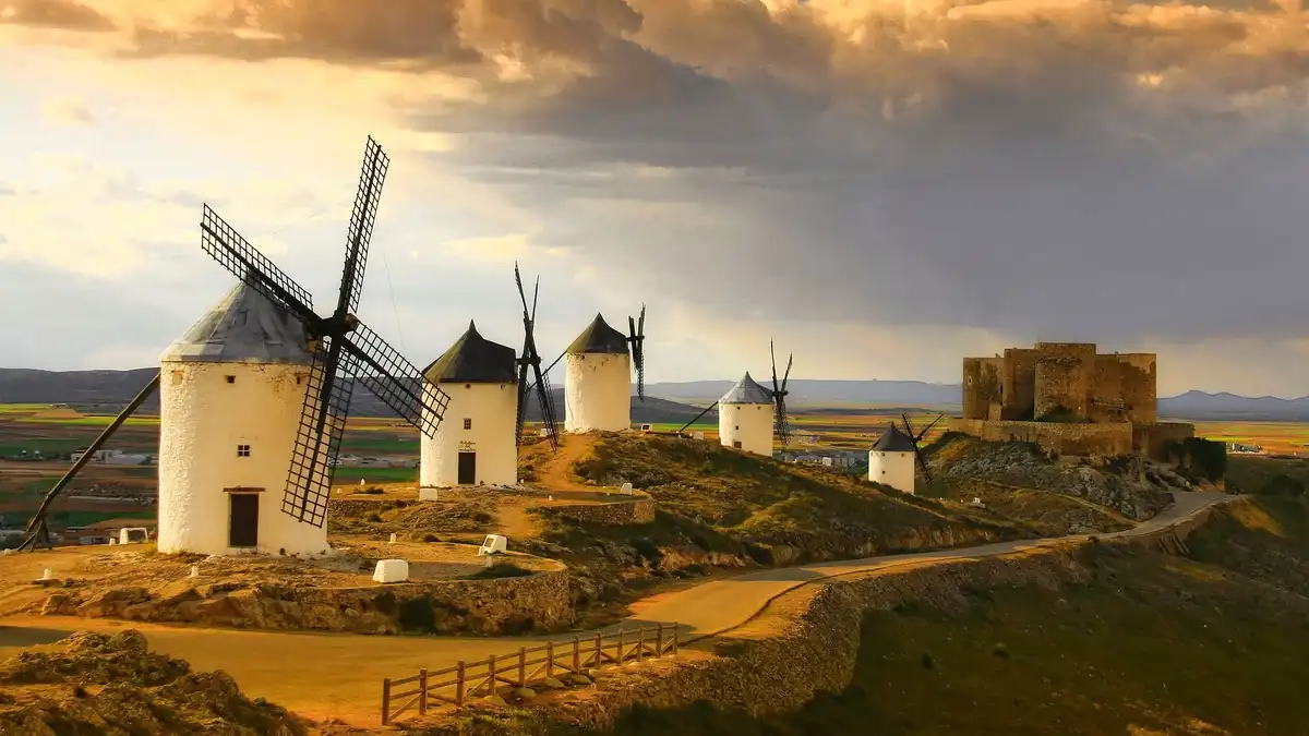 Here, on a scrubby ridge, stone windmills stand guard, their imposing forms evoking the legendary giants of Don Quixote's…