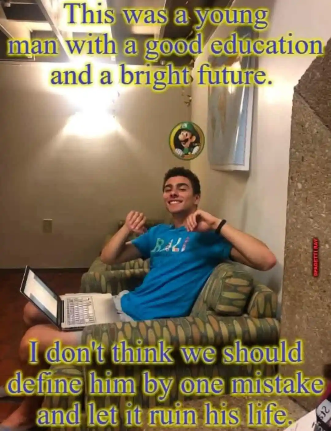 A young man in a blue t-shirt sits relaxed in a patterned armchair with a laptop on his lap, smiling confidently. The image…