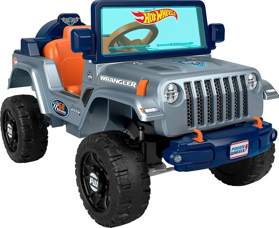 A child's electric toy Jeep Wrangler with a silver body, orange interior, and blue accents, featuring the 'Hot Wheels' logo…