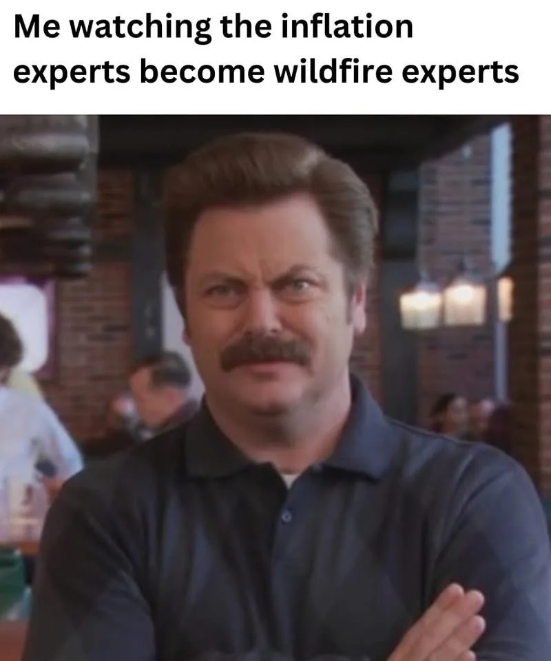 A man with a mustache and arms crossed stares skeptically at the camera, overlaid with the text 'Me watching the inflation…