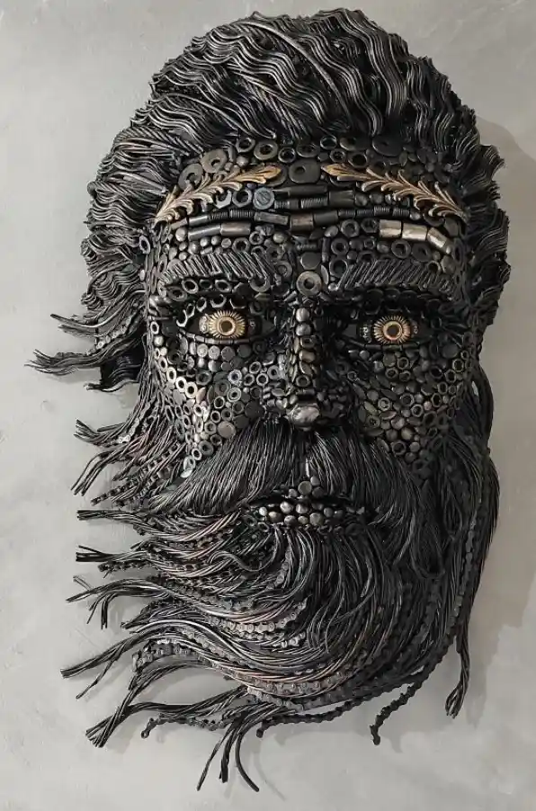 A detailed metal sculpture of a bearded man's face, constructed from various metal parts like bolts, washers, and wires…