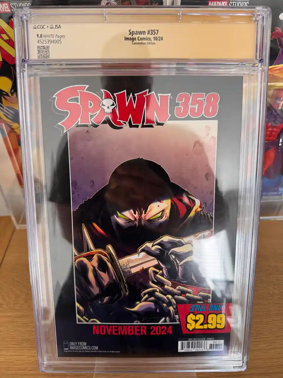A comic book titled 'Spawn #357' is encased in a protective slab with a CGC grading label. The cover art depicts the…