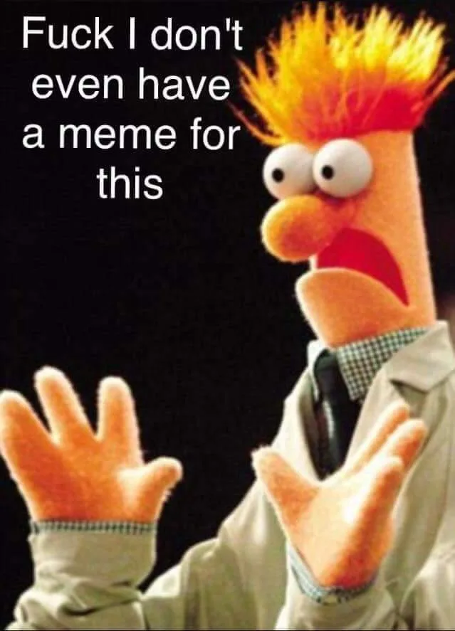 A close-up of the Muppet character Beaker, with his signature spiky orange hair, wide eyes, and open mouth, wearing a white…