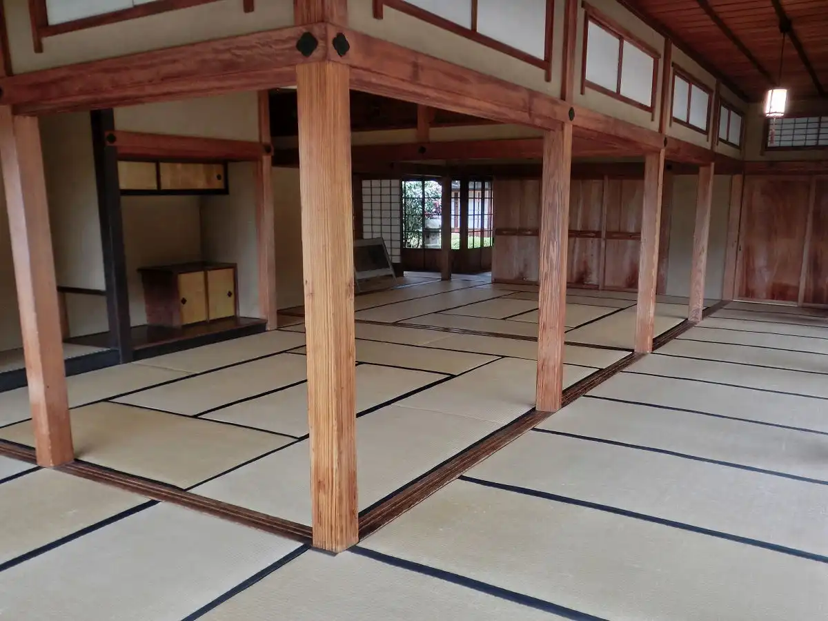 An empty traditional Japanese room with wooden pillars, tatami mats, and sliding doors, overlaid with the text 'i'm not…