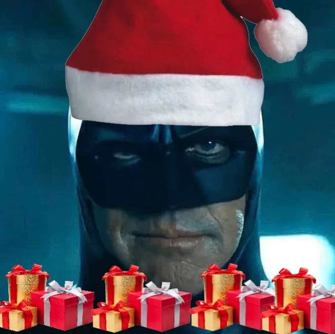 A close-up of Batman wearing a red and white Santa hat, with a stern expression, surrounded by numerous red and gold wrapped…